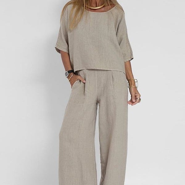 Woman wearing the Arianah relaxed-fit two-piece set in light gray, showing the full coordinated top and trouser look