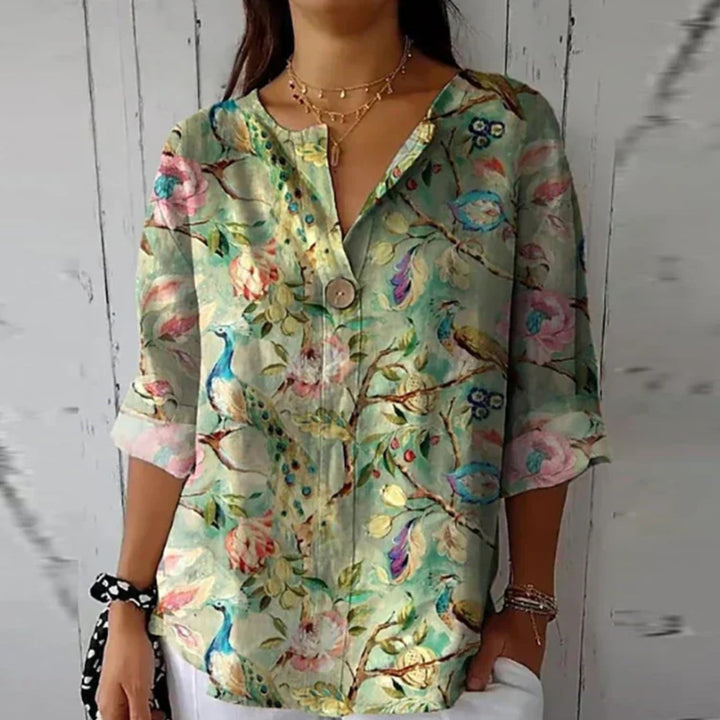 Model styling the Arlene floral blouse with heels for a polished, elegant look