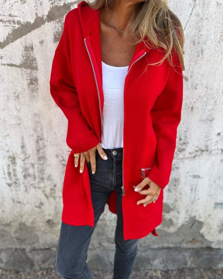 Woman wearing a long sleeve zip-front cardigan with a round neckline, shown in a warm solid color