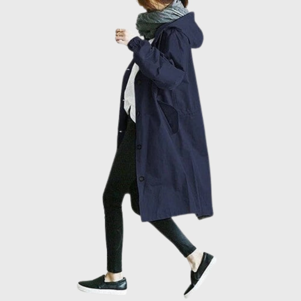 Side profile of the Arline trench coat in light blue showing elongating fit