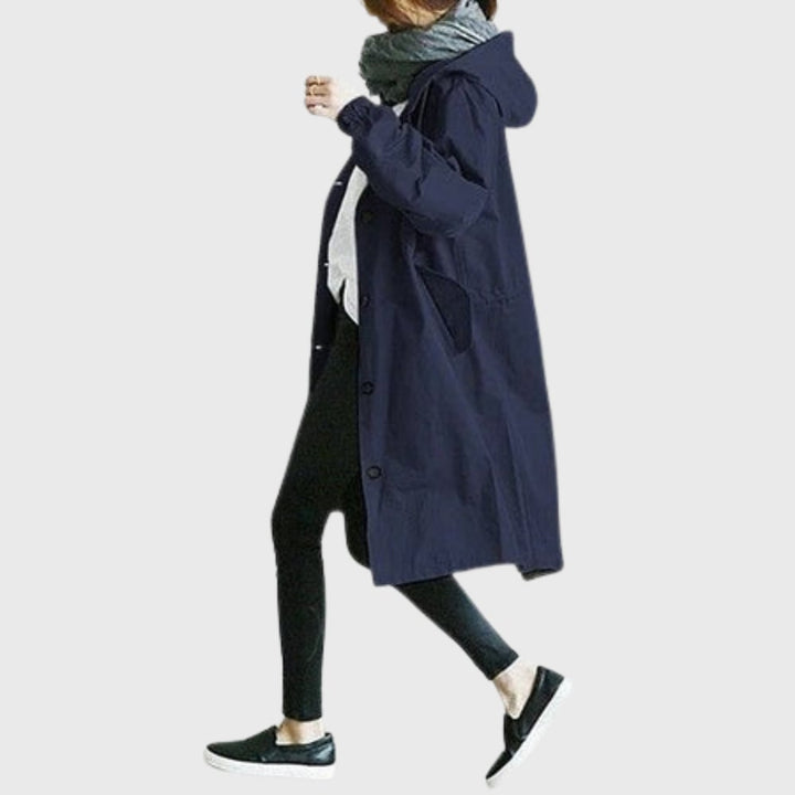Side profile of the Arline trench coat in light blue showing elongating fit