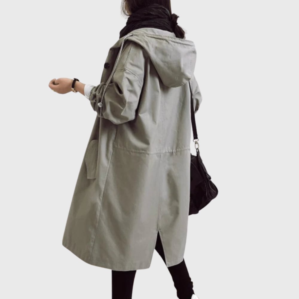 Arline waterproof trench coat in blue worn in an outdoor setting