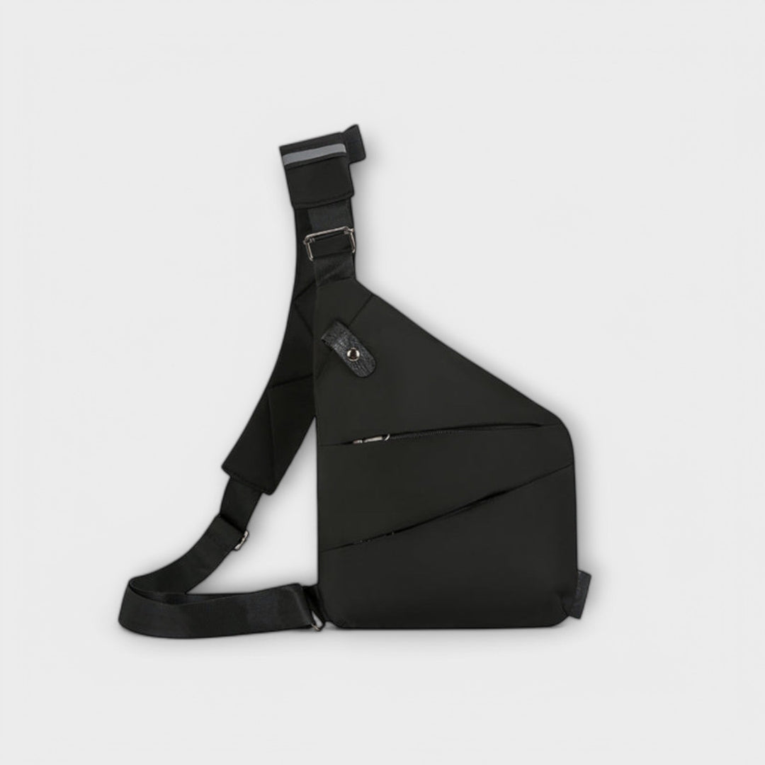 Gray crossbody bag with modern design worn crossbody on a woman in an urban setting