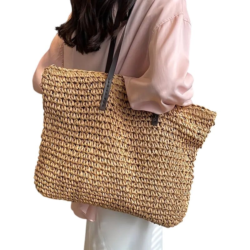 Beige beach tote bag with shoulder straps displayed against a neutral backdrop