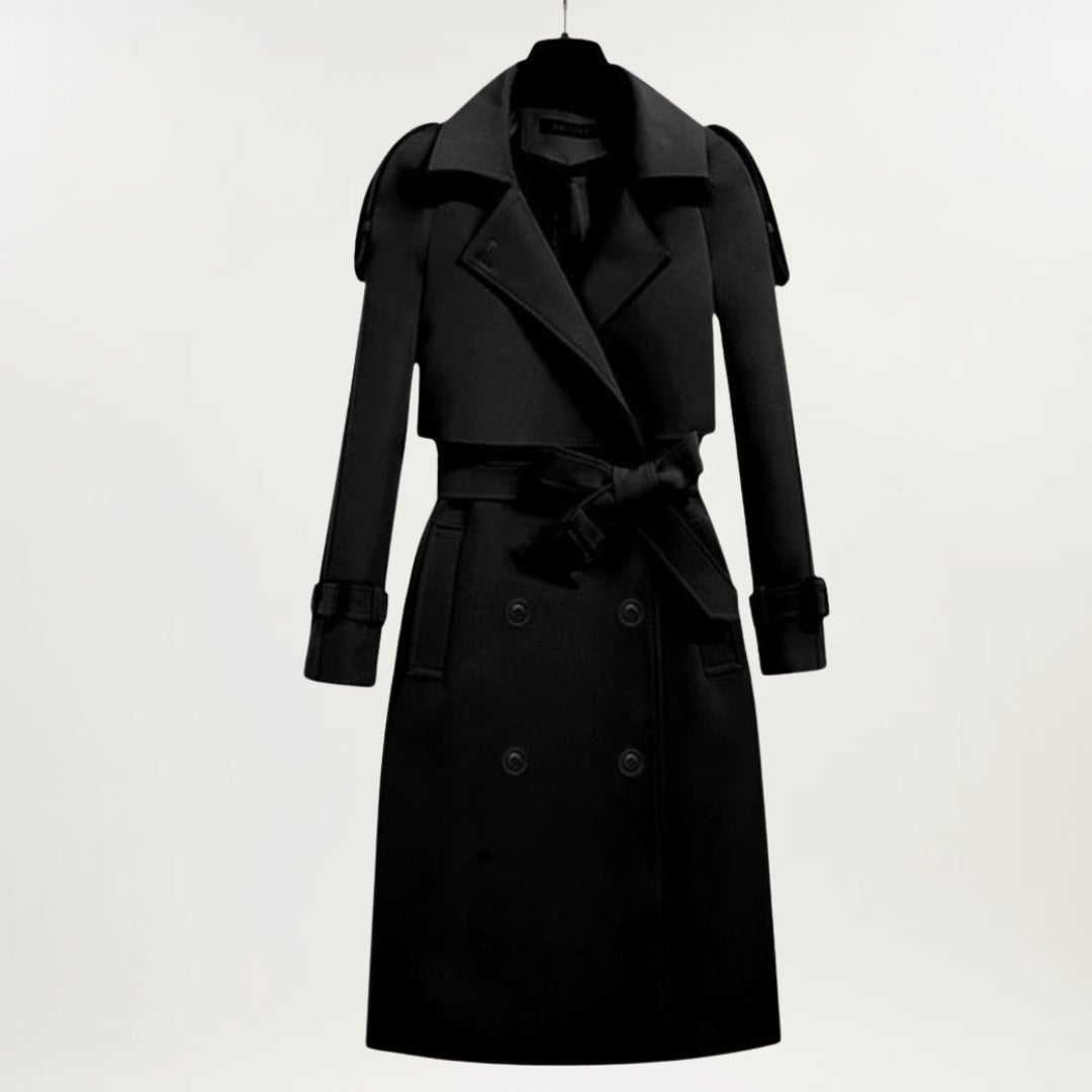 Close-up of the longline trench coat showing buttoned cuffs and structured fabric detail