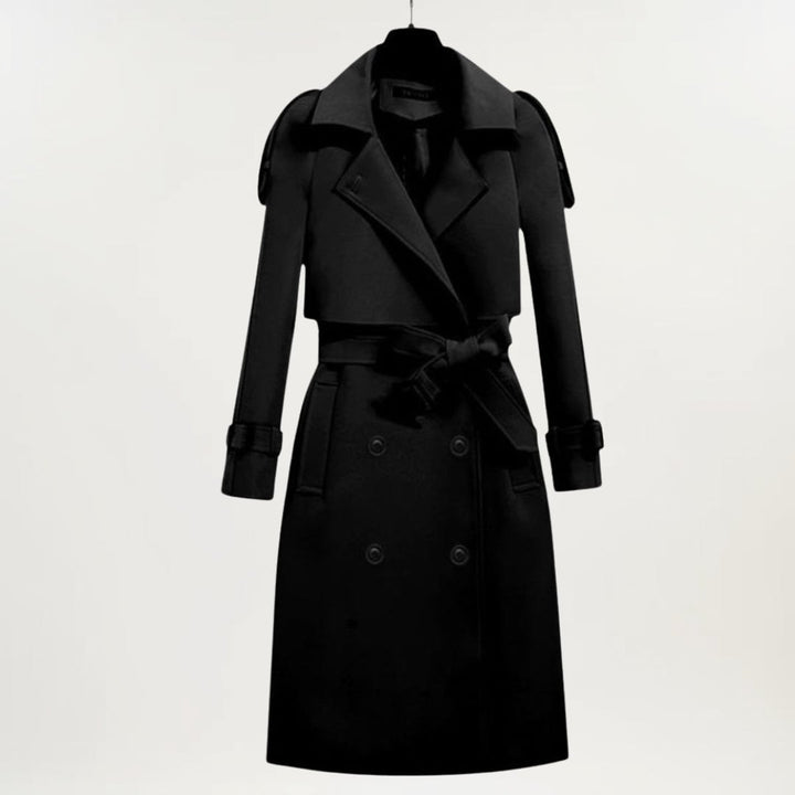 Close-up of the longline trench coat showing buttoned cuffs and structured fabric detail