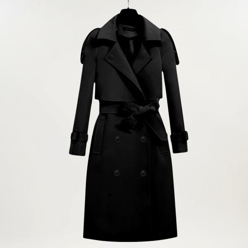 Close-up of the longline trench coat showing buttoned cuffs and structured fabric detail