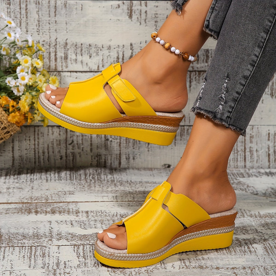Close-up of Aster sandal sole and heel in orange colorway
