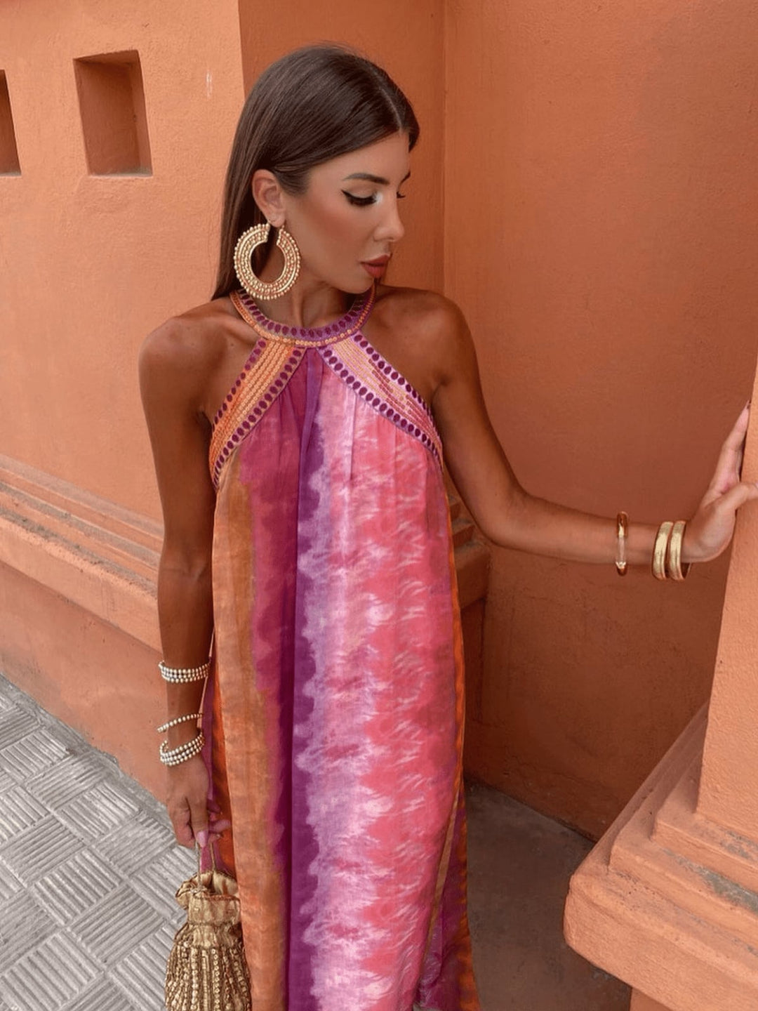 Woman wearing the Aster multicolor ombre dress with a flowing silhouette, perfect for summer weddings