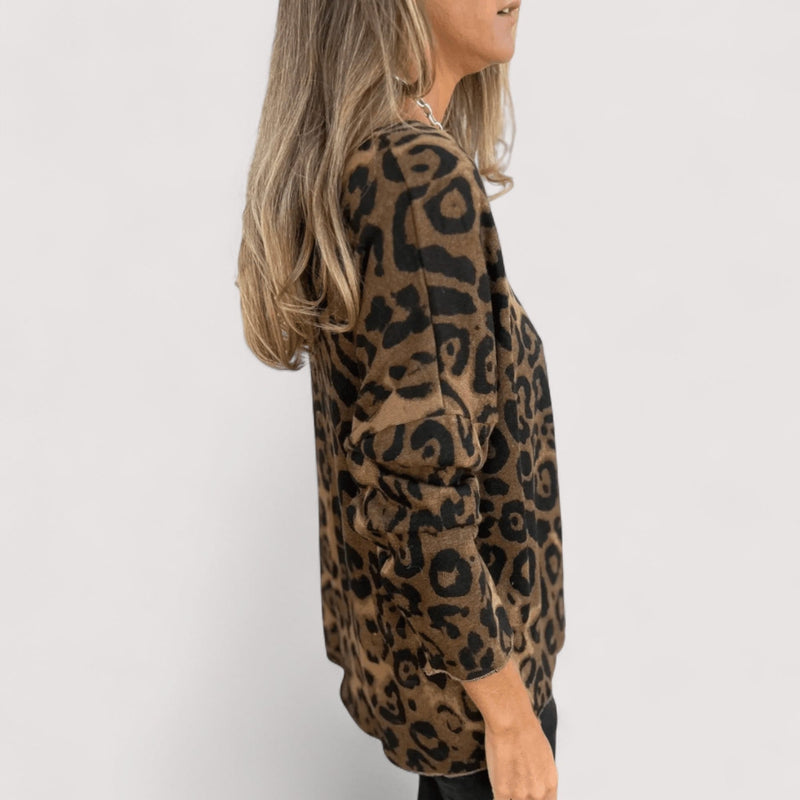 Close-up of leopard print fabric detail on a lightweight women's top in brown