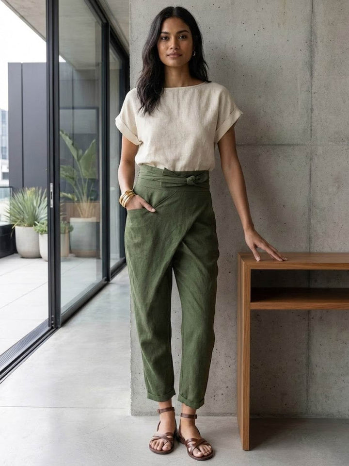Side view of army green wrap front tapered pants with rolled cuff detail