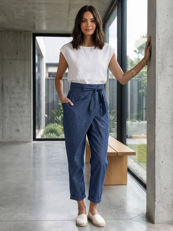 Side view of navy blue tapered cropped pants showing wrap drape
