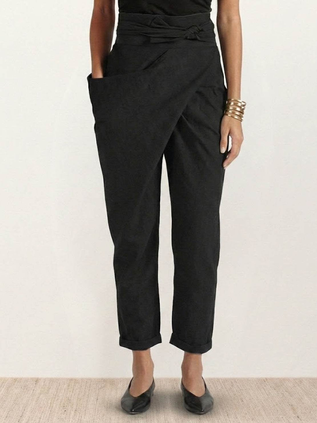 Front view of black high waist wrap front cropped tapered pants
