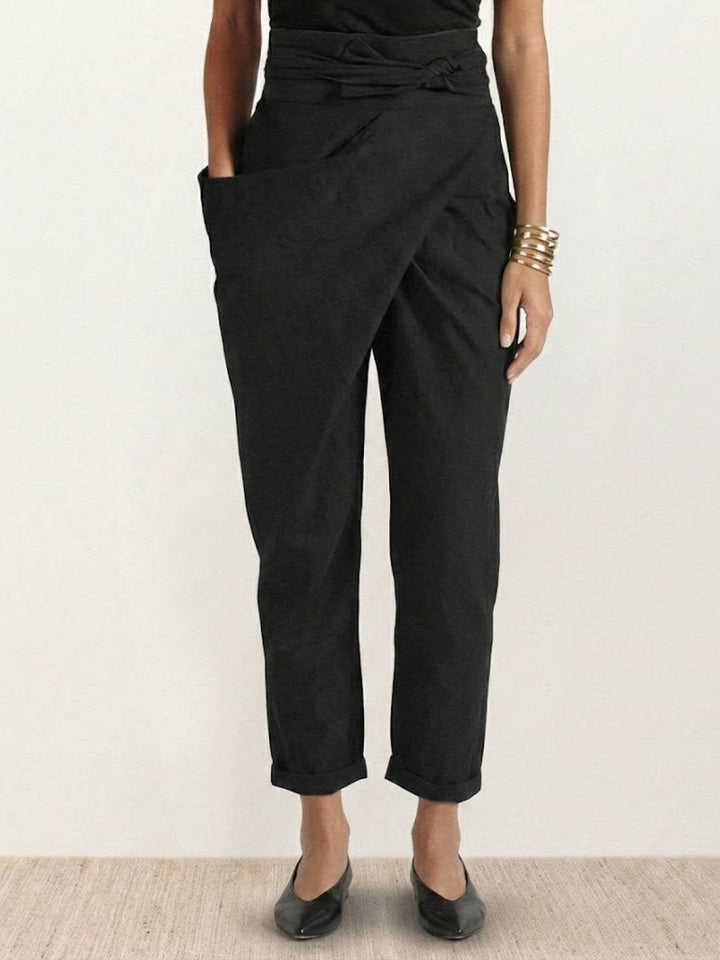 Front view of black high waist wrap front cropped tapered pants