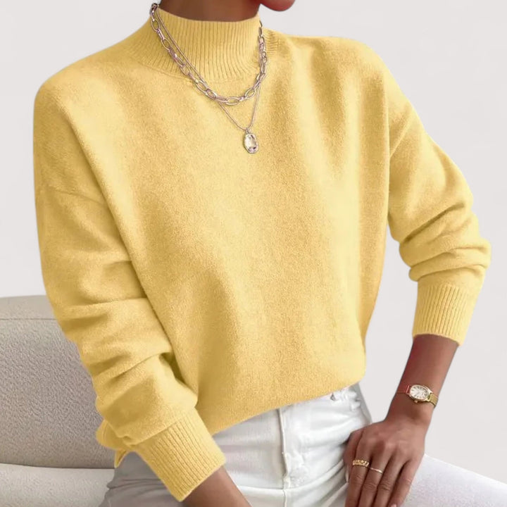 Model in a light pink turtleneck sweater styled for a casual everyday look