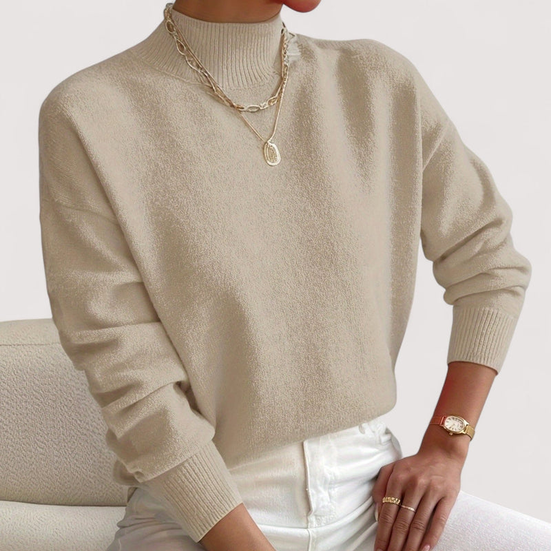Front view of a beige turtleneck sweater draping smoothly over the silhouette