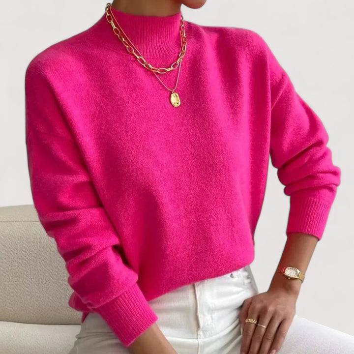 Side profile of a model in a soft yellow turtleneck sweater showing sleeve length