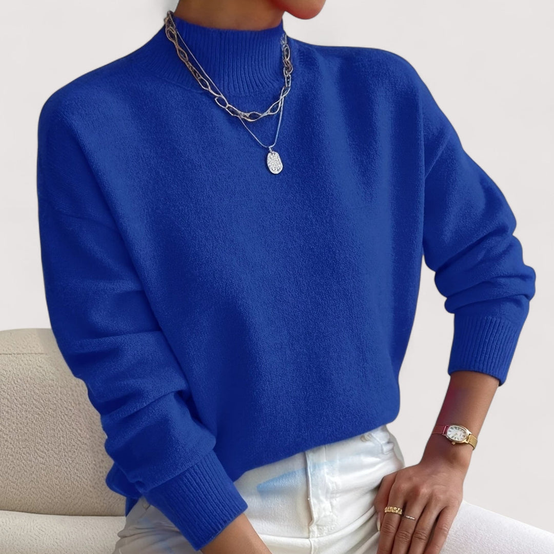 Woman in a blue turtleneck sweater showcasing the relaxed yet polished fit