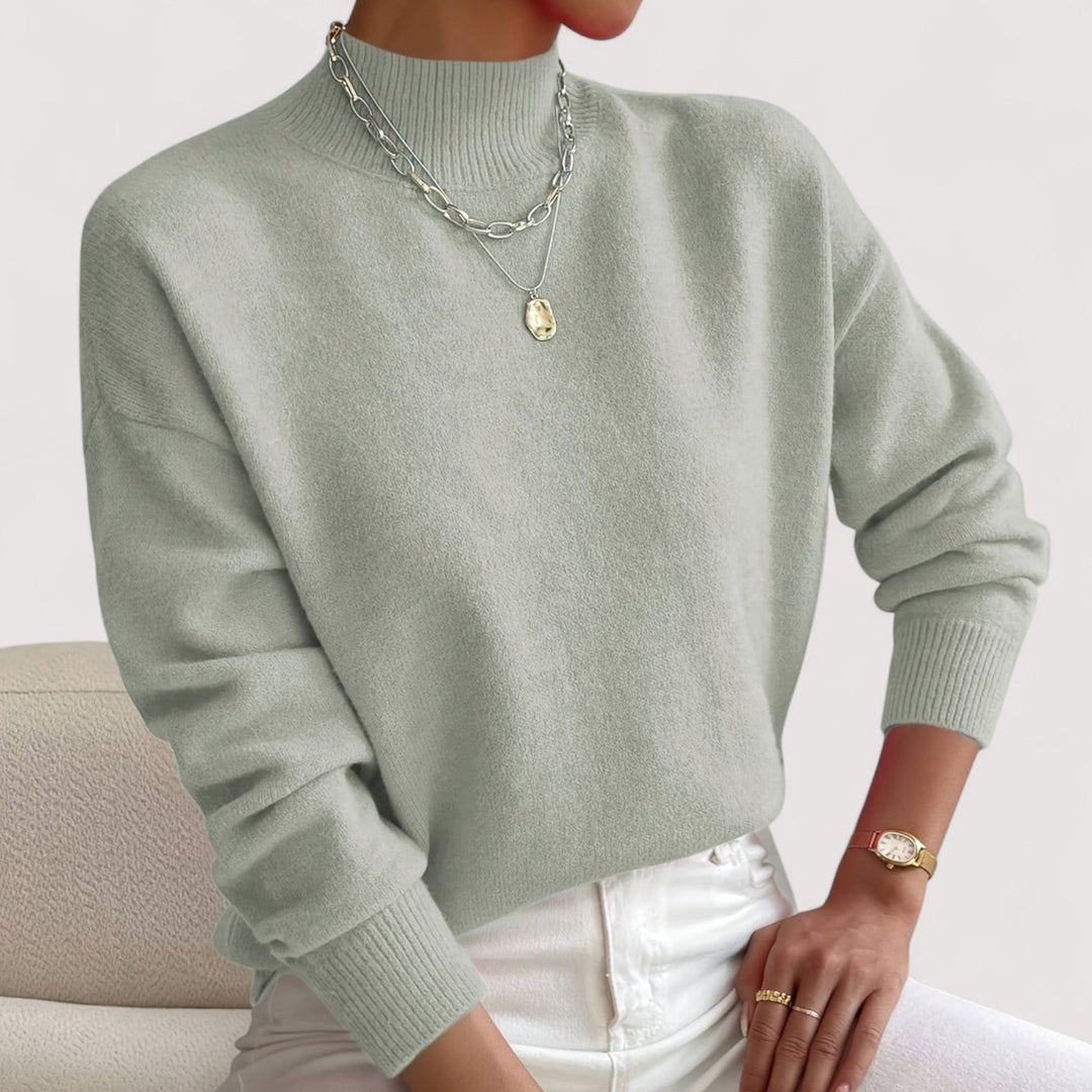 Overhead flatlay of multiple turtleneck sweater color options including white, beige, and black