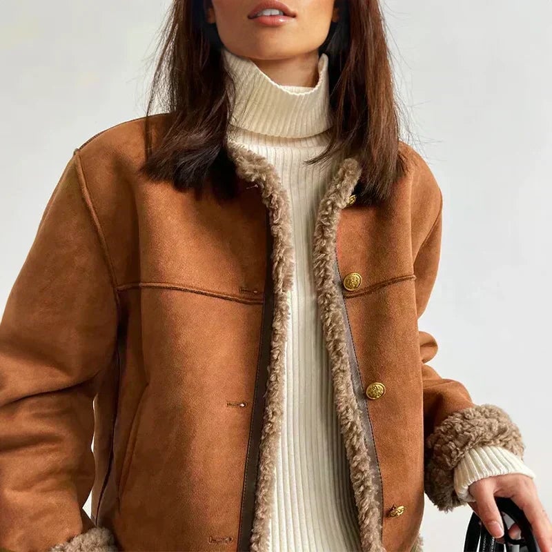 Woman wearing a brown tailored jacket with a structured silhouette and classic design