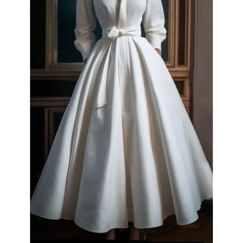 Back view of a white long sleeve midi dress with full A-line skirt falling to midi length