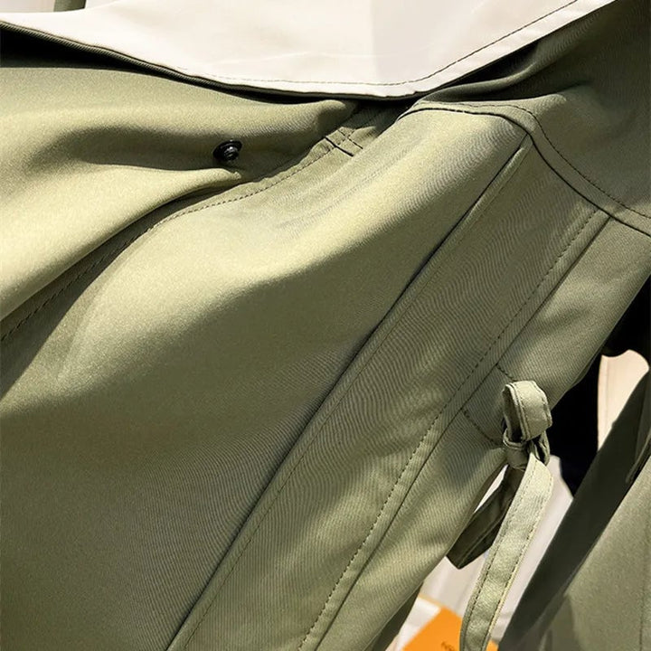 Aurelia windbreaker jacket in black showing button placket and zipper overlay