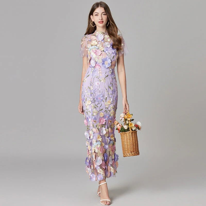 Close-up of 3D floral appliqués on the Aurelia sheer mesh maxi dress in yellow