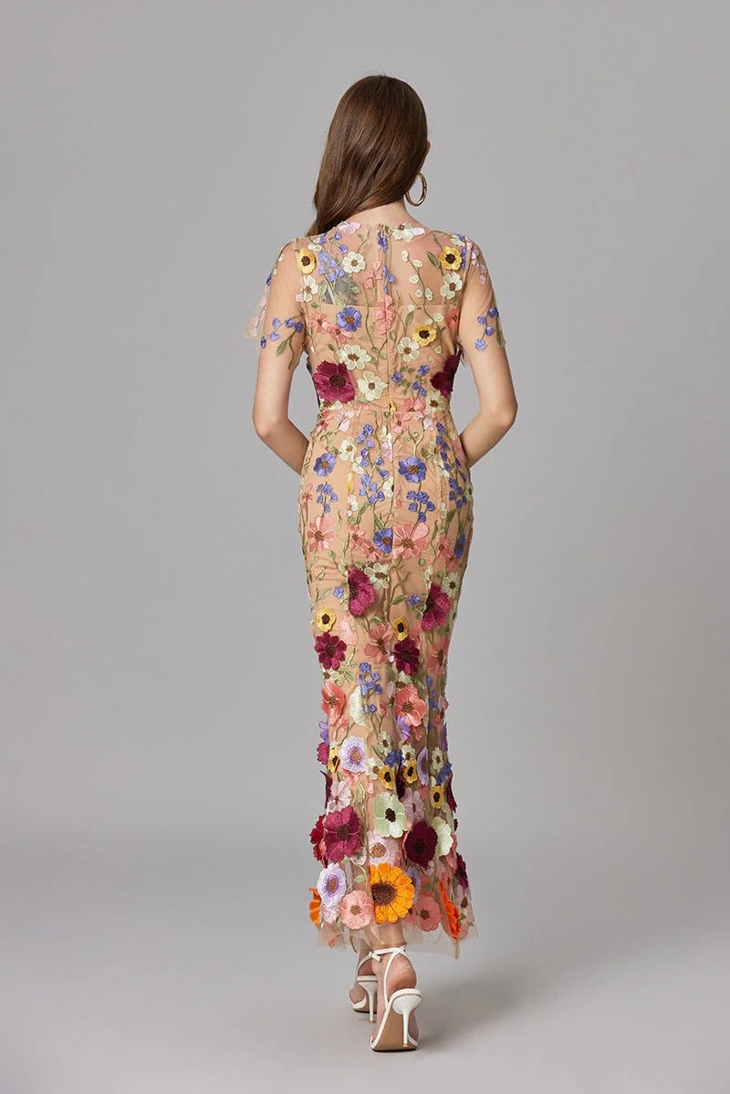 Close-up of sculptural 3D floral appliqués on the Aurelia maxi dress in purple