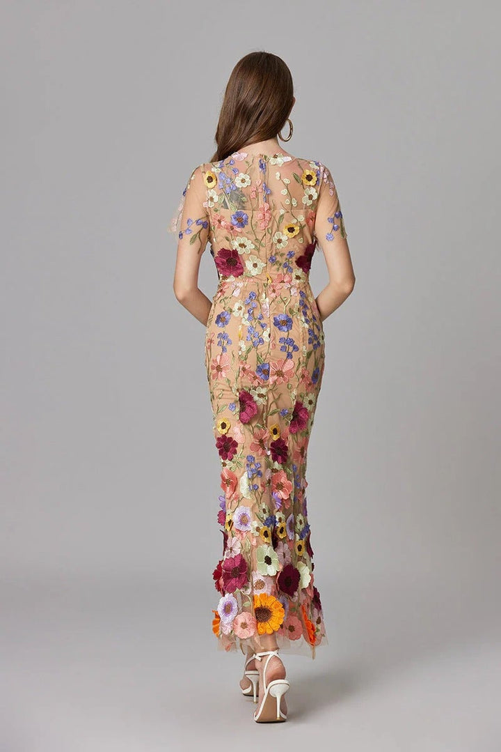 Close-up of sculptural 3D floral appliqués on the Aurelia maxi dress in purple