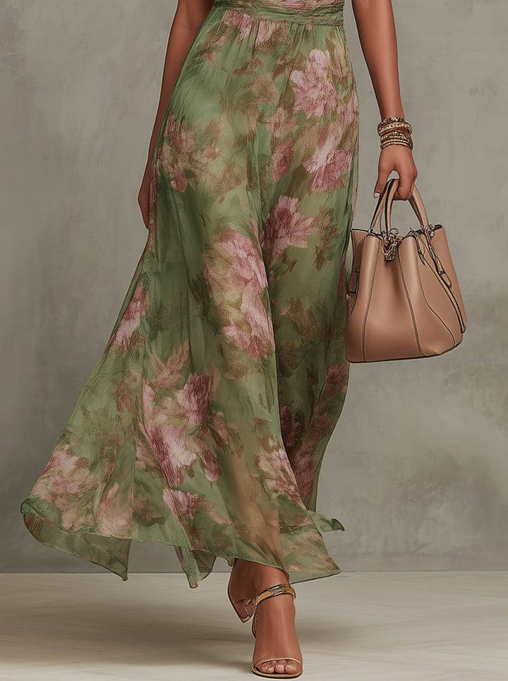 Close-up detail of the Aurelia maxi dress fabric showing the romantic green and pink botanical floral print