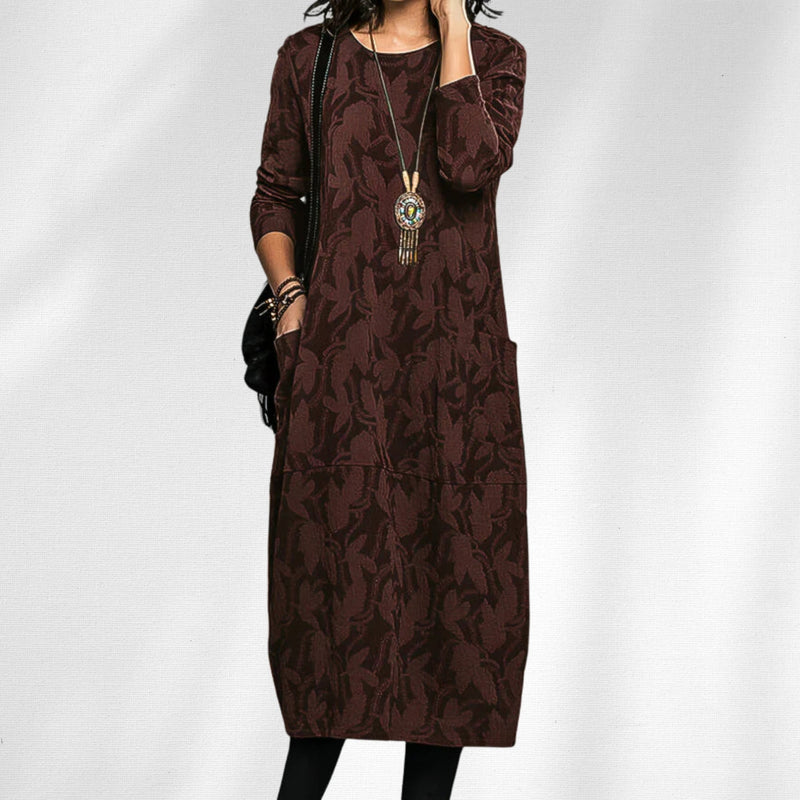 Close-up of the Aurora crewneck winter dress showing fabric texture and floral accent details