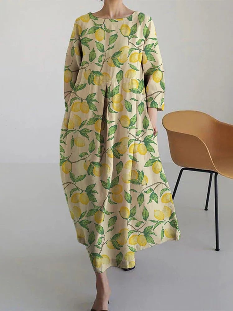 Woman wearing the Aurora flowy midi dress in a vibrant lemon print, featuring a relaxed silhouette and elegant midi length perfect for summer