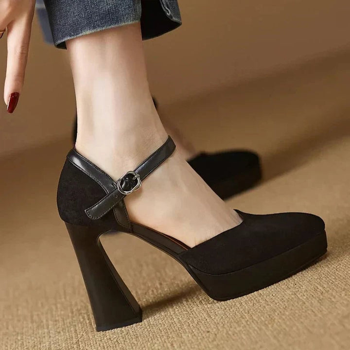 Aurore black pump close-up of polished metal ankle strap buckle hardware