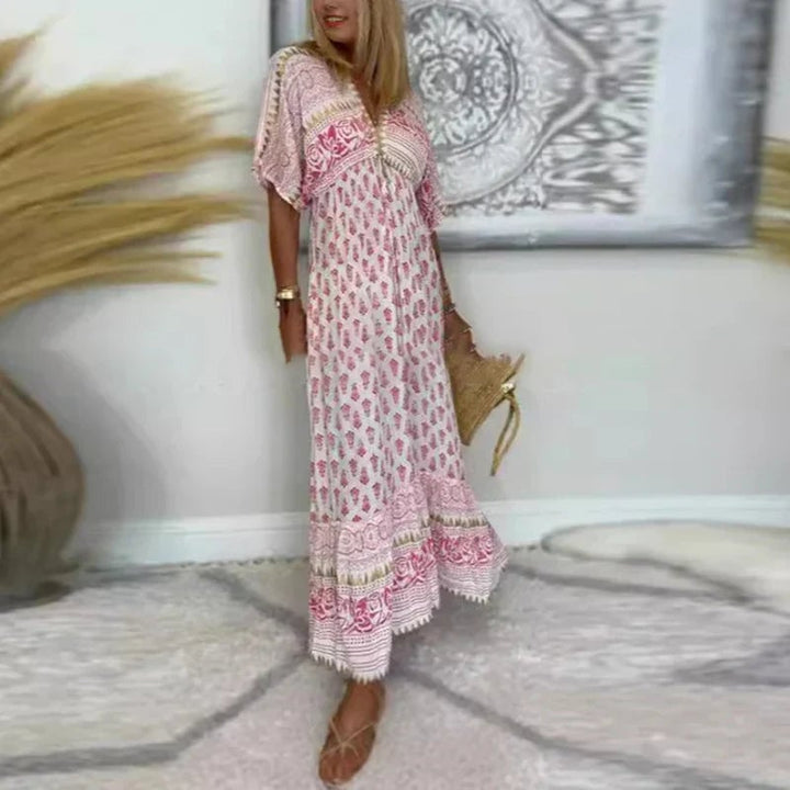 Close-up detail of the artful boho print on a pink maxi dress showing the pattern and fabric drape