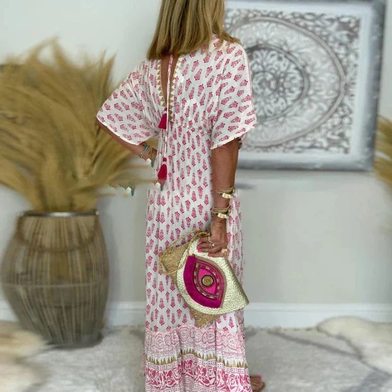 Full-length view of a pink boho maxi dress on a model, highlighting the floor-grazing length and relaxed fit