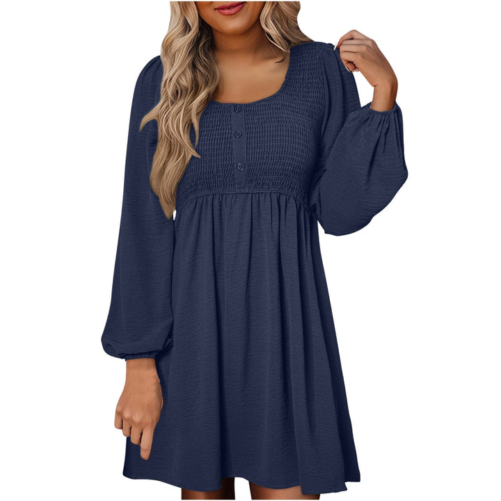 Model wearing smocked mini dress in black with balloon sleeves