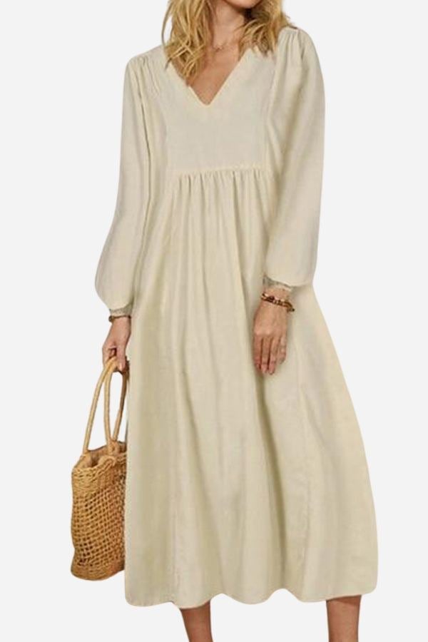 Back view of woman in a red brick balloon sleeve midi dress showing full skirt drape