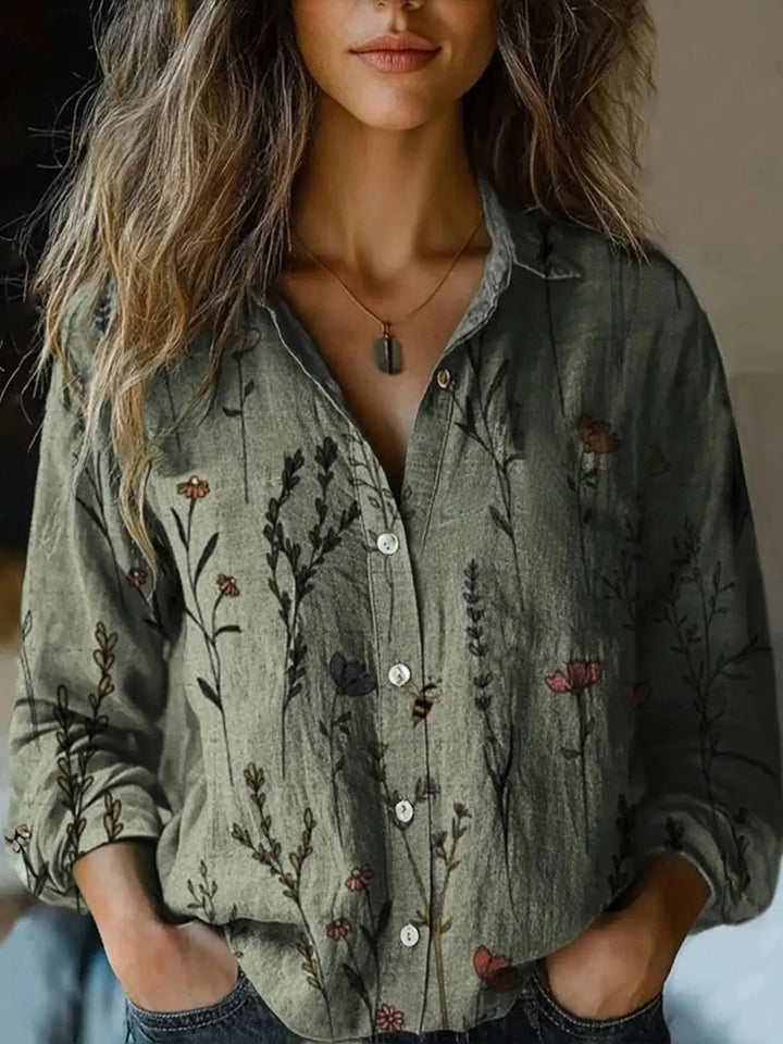 Back view of women's long sleeve floral print button-down shirt in dark green