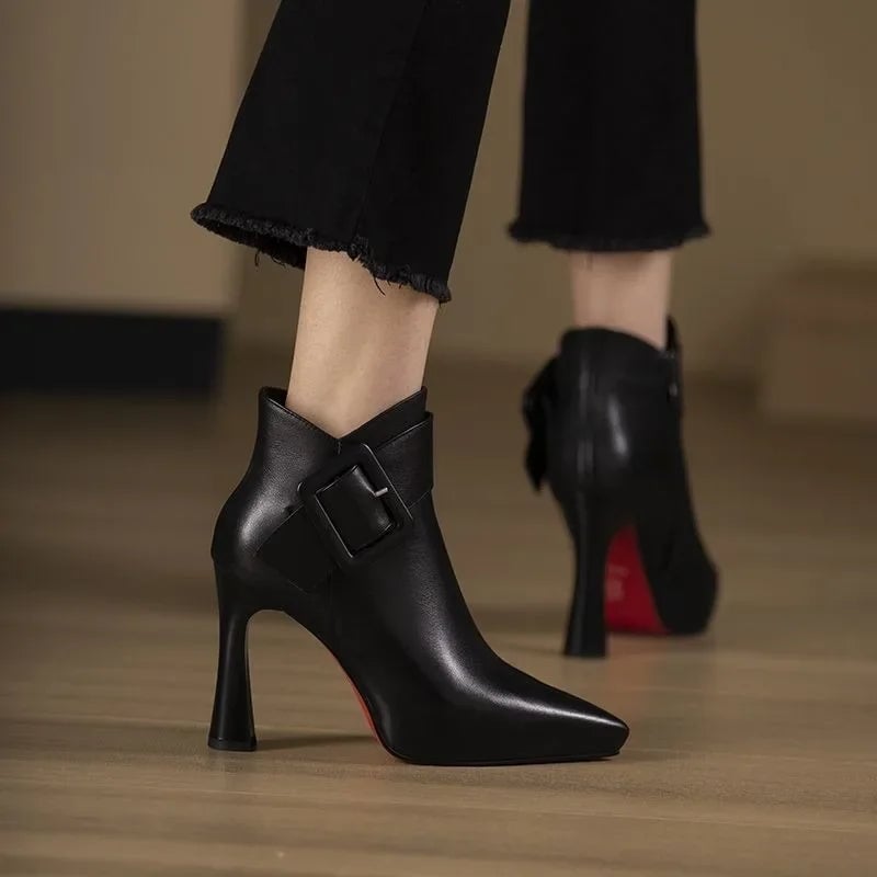 Aveline buckle heel boots in black shown from the back highlighting contoured heel