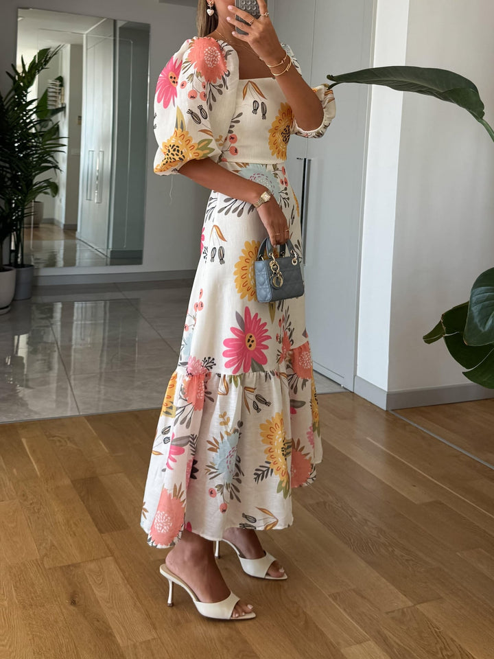 Full-length view of a floral square neck midi dress with puff sleeves styled for a casual daytime look