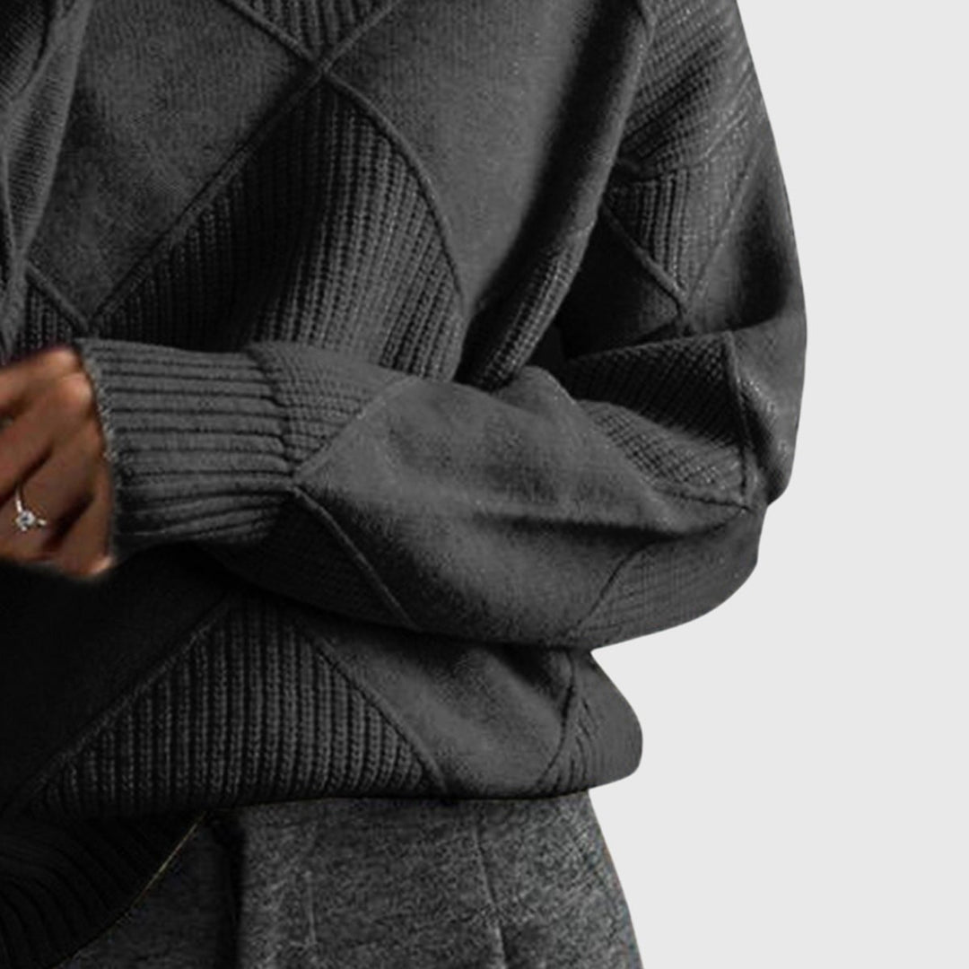 Full-length shot of model wearing the Avery turtleneck sweater paired with trousers