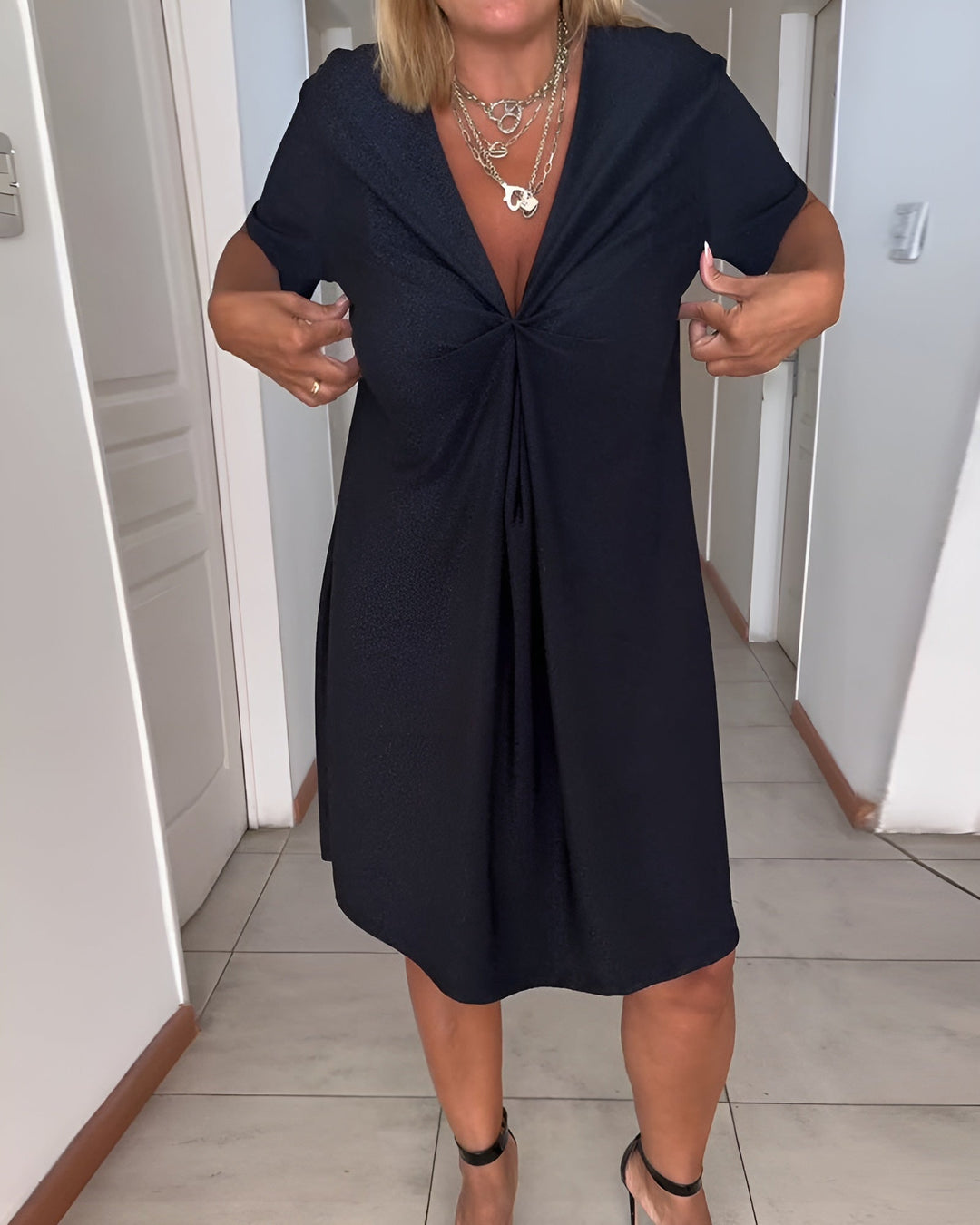 Woman wearing the Avery black V-neck ruched evening dress, front view showing tummy control waist detailing