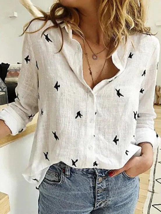 Flat lay of the Avery bird print blouse showing the all-over bird motif pattern