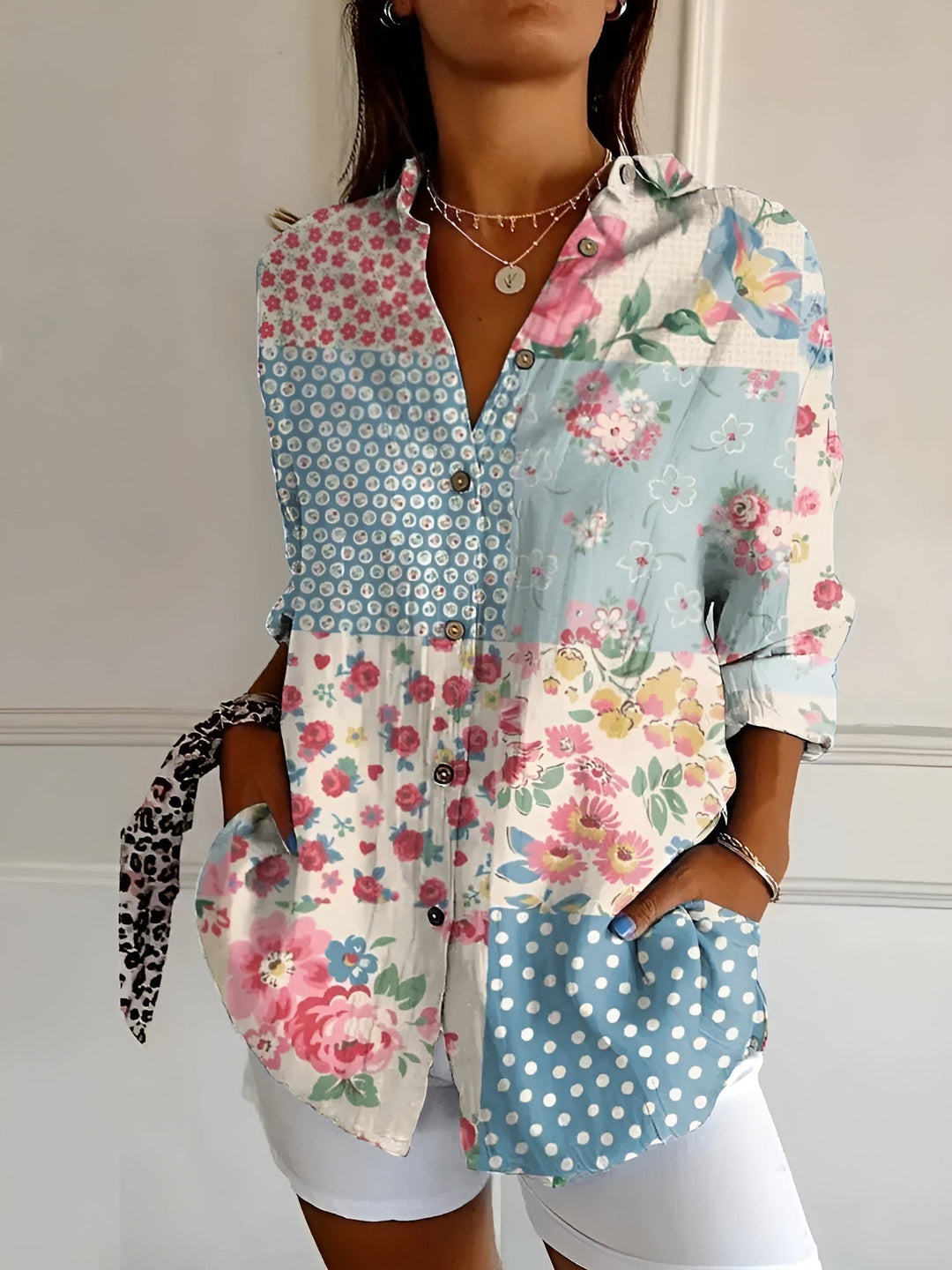 Close-up detail of the Avril blouse floral print pattern in soft blue tones
