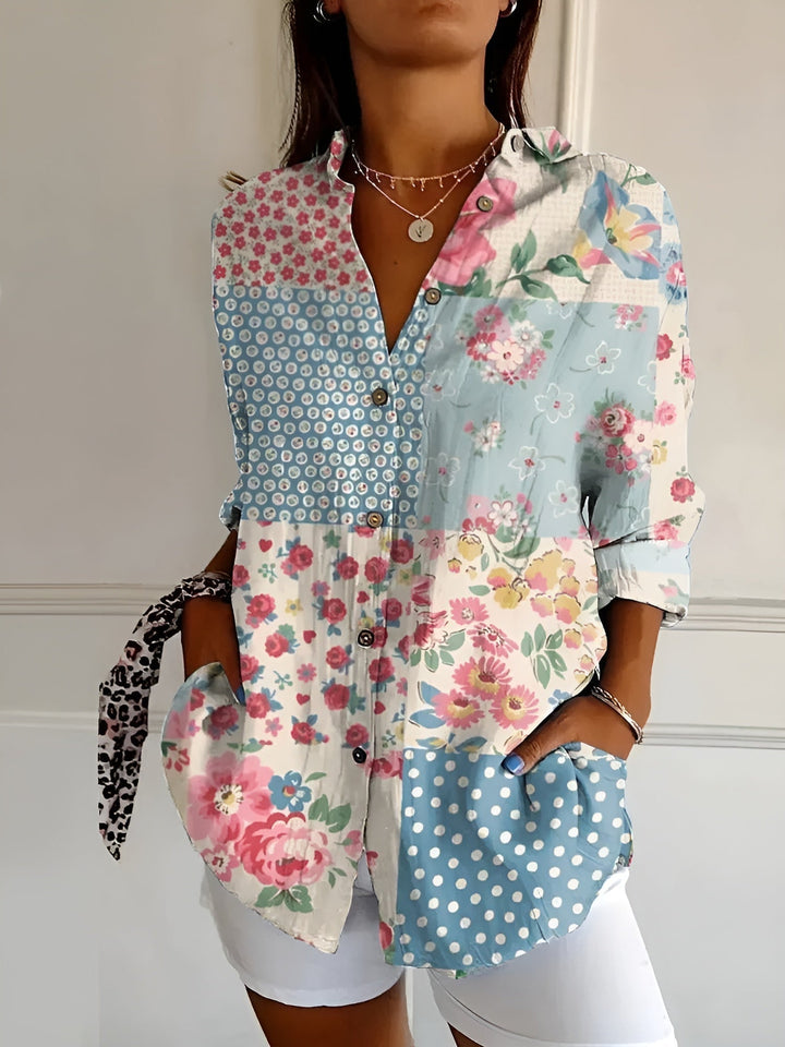 Close-up detail of the Avril blouse floral print pattern in soft blue tones
