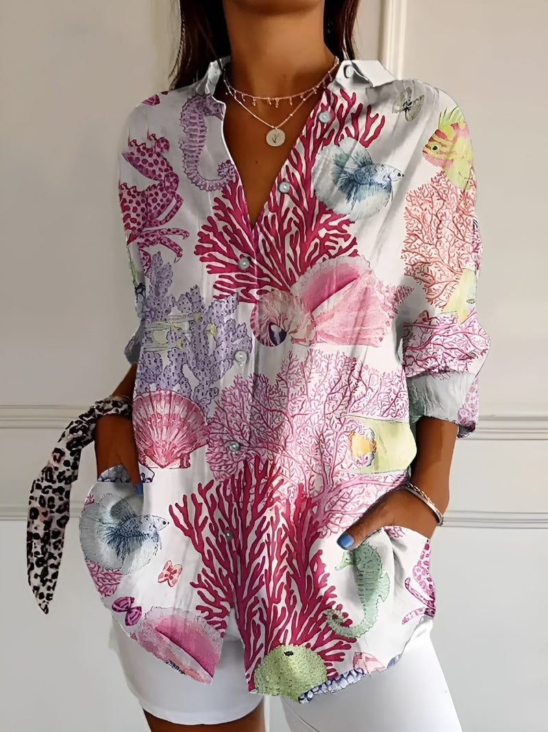 Model wearing the Avril blouse in pink floral print paired with a white skirt for a polished look