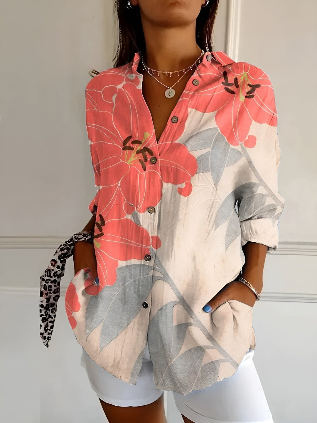 Flat lay of the Avril blouse in dark blue floral print showing full design detail