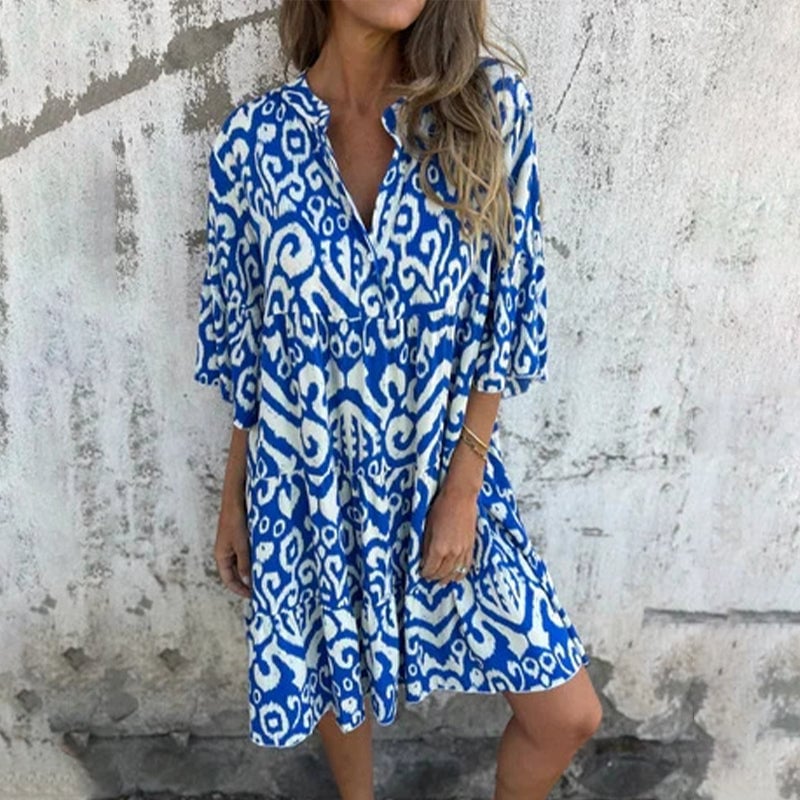 Front view of the Azalea printed draped dress in blue with elegant draping and printed sleeves