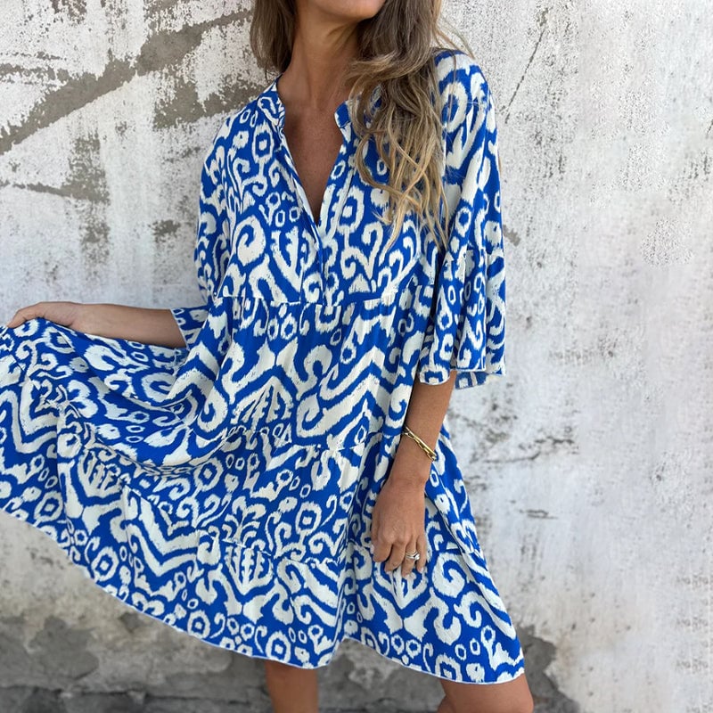 Back view of the Azalea draped dress showing flowing silhouette and printed sleeve detail
