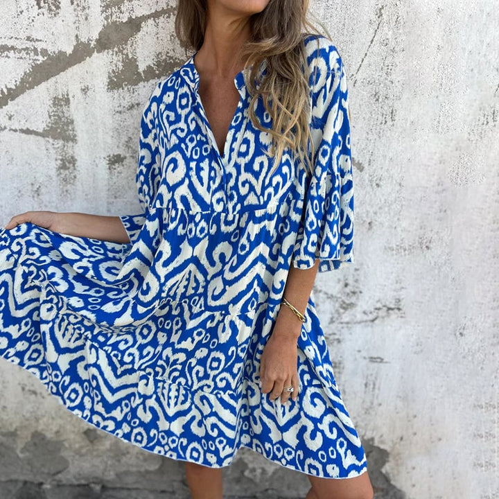 Back view of the Azalea draped dress showing flowing silhouette and printed sleeve detail